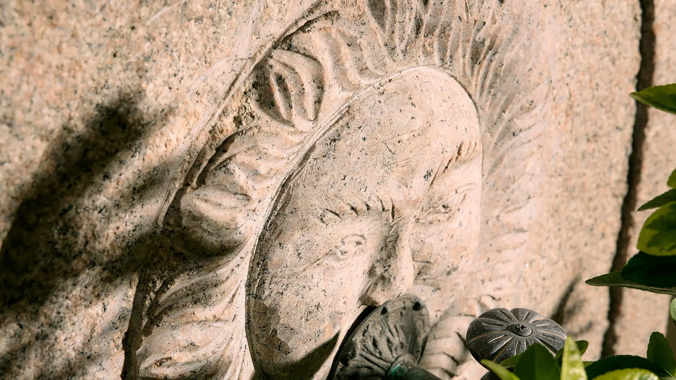 A carved face in weathered stone, close up