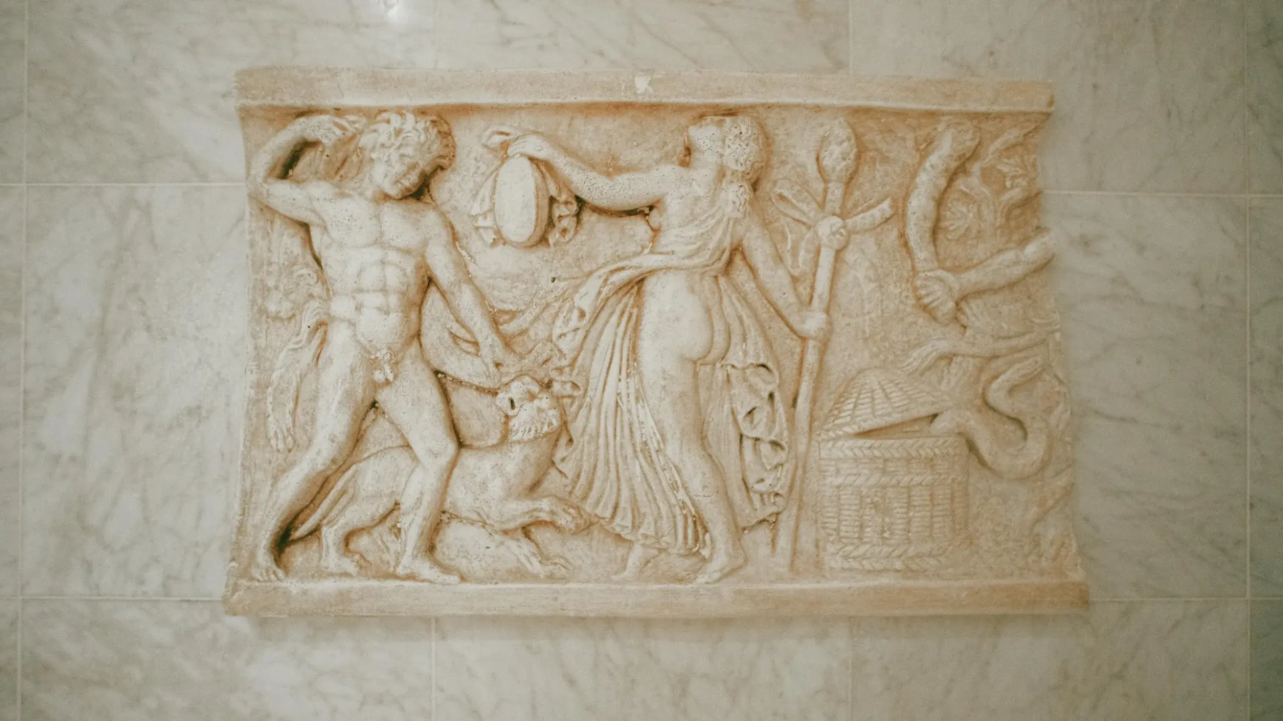 A carved Roman marble relief set into a marble wall